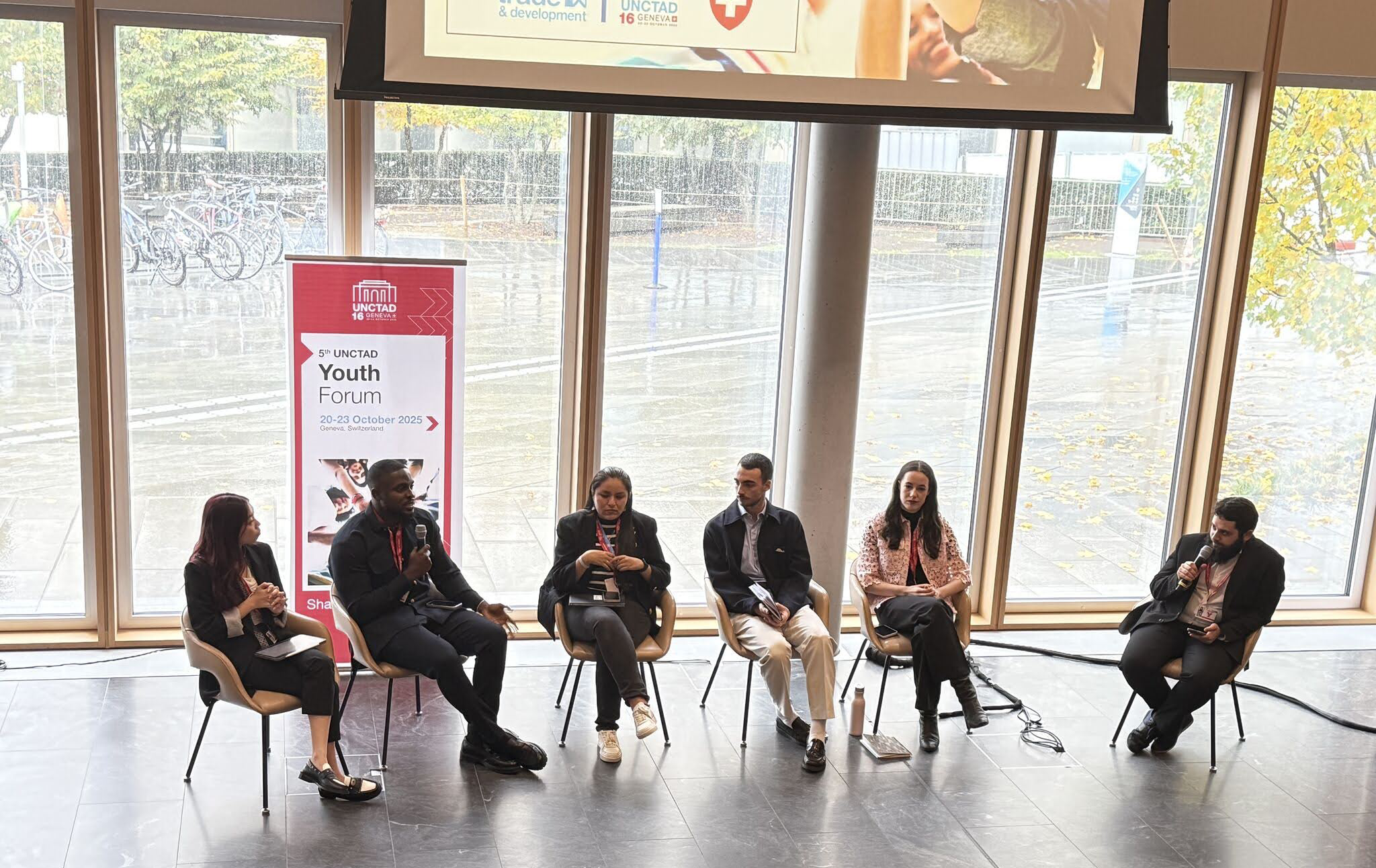 “Green Rising: Young Adults Shaping a Sustainable Future,” the opening discussion of the 5th UNCTAD Youth Forum. Image of six people sitting in a row inside a building.