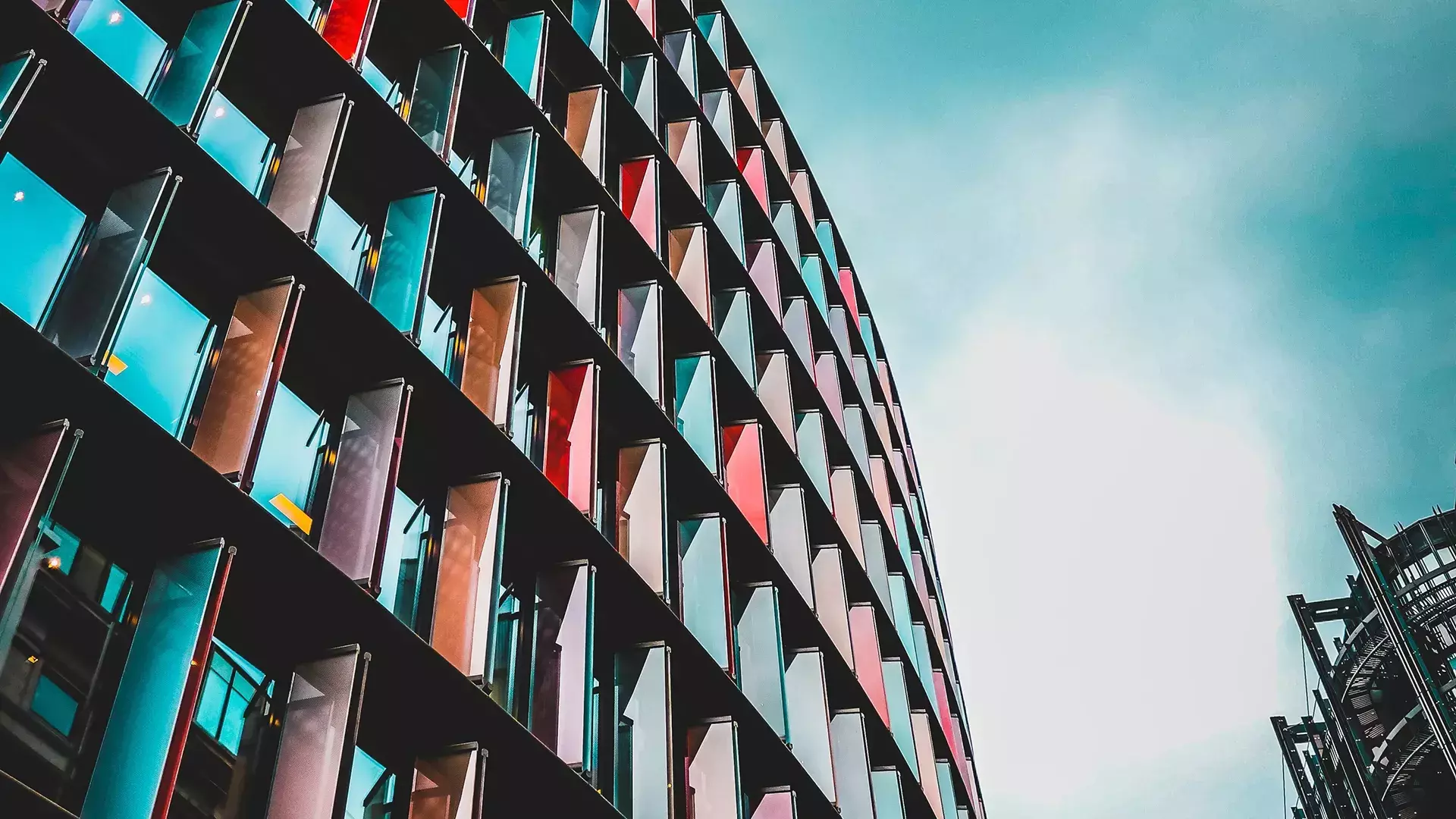 curved building against a cloudy sky