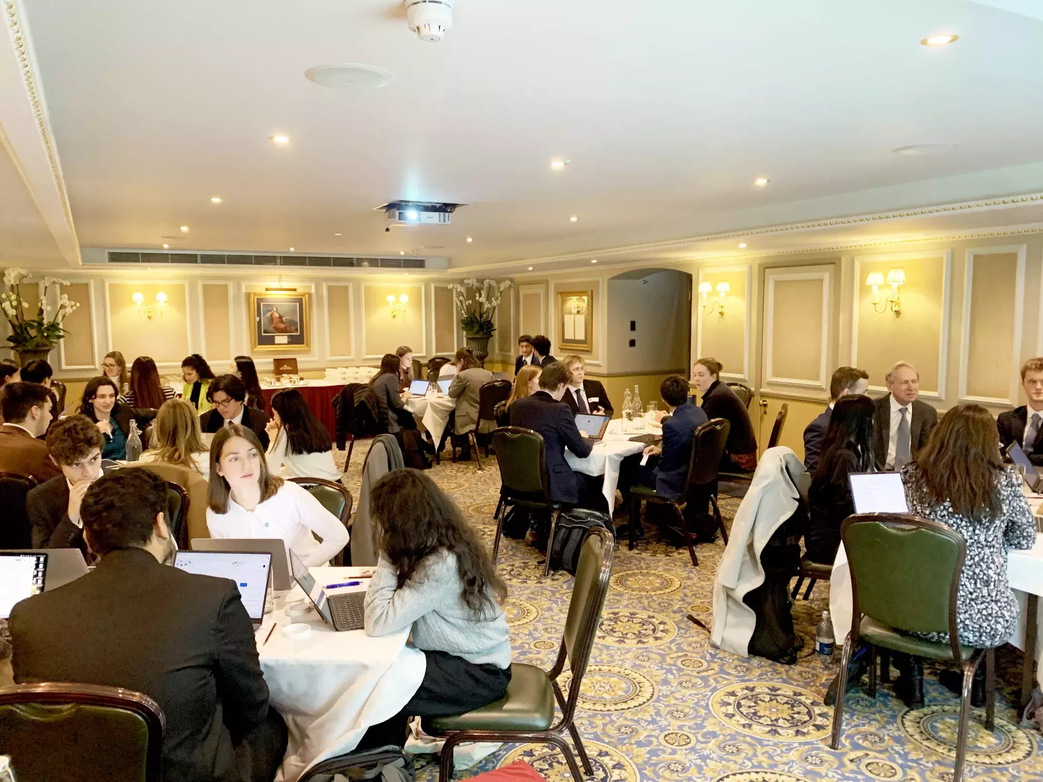 Image of hackathon participants sitting at their tables in the venue
