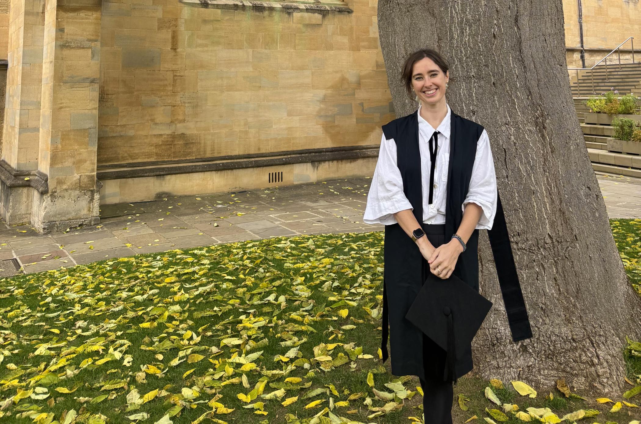 Woman smiling standing by tree